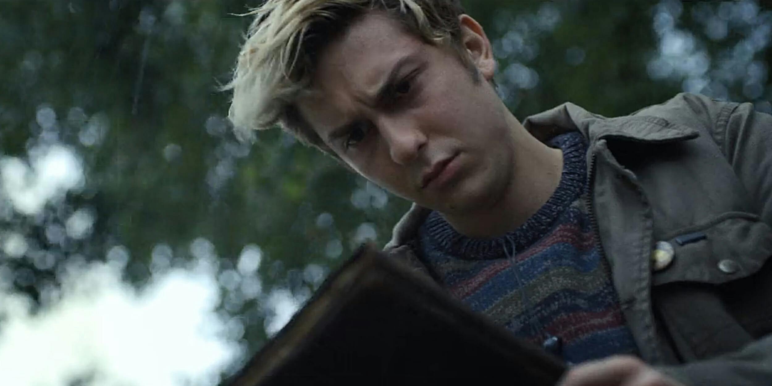 Young man looking at book